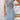 Women's sleeveless light wash denim bodycon midi dress showcasing a fitted design, highlighting the waist and falling to the thighs, with a focus on the neckline and shoulder area.