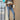 Women's striped crew neck multicolor sweater paired with jeans, featuring vibrant fall fashion knitwear with long sleeves and a casual outerwear style.
