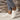Women's stylish white lace-up sneakers with comfortable low-top design, worn with jeans.