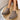 Women's stylish white platform high-top slip-on sneakers on a beige and grey flooring background, showcasing the shoes' sleek design and comfortable fit around the calf and thigh area.