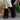 White platform high-top slip-on sneakers worn by a person standing on grass.