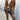 Women's tan fringed suede jacket with boho chic style, featuring long sleeves, a collar, and fringe detailing along the hem and sleeves, suitable for fashionable layering.