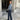 Women's trendy grey wool cropped trucker jacket with long sleeves and a collar, styled as winter outerwear. The jacket features a waist-length fit and resembles a blazer with denim-like appearance.
