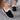 Women's turquoise fur-lined slip-on shoes displayed against a white background, showcasing stylish winter footwear design with black and blue elements.