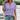 Women's short sleeve V-neck textured blouse with geometric patterns in purple.