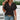 Woman wearing a short sleeve V-neck textured blouse with a geometric pattern, paired with jeans.