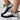 Women's white and black knit slip-on sneakers with a breathable and lightweight design, suitable for walking and outdoor activities.