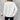 Women's white cable knit sweater worn as a stylish winter fashion pullover, featuring a cozy and textured design.