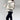 Women's white faux fur winter jacket with long sleeves, styled as cozy street wear.