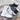 Women's white fur-lined lace-up ankle winter boots on a plain background.