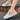 Women's stylish low-top white lace-up sneakers with a durable sole, designed for walking and featuring fashion-forward design elements.