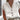 Women's white linen blouse with short sleeves, a V-neck, and button-down front, ideal for summer wear.