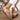 Women's white rhinestone flat strappy ankle sandals displayed on a model's foot, highlighting the elegant design and sparkling rhinestone details.