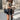 Women's white shearling vest featuring a chic urban winter fashion style, highlighting the outerwear's stylish design with visible shoulder details, a cozy beige textile, and a fashionable sleeveless cut.