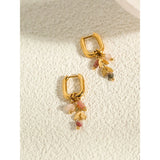 18K Gold Hoop Earrings with Pink Gemstone and Gold Leaf Charm, featuring circular design and natural materials.