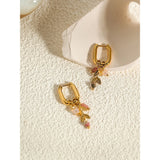 18K gold hoop earrings with pink gemstone and gold leaf charm from Ya-Chan, elegant and stylish body jewelry.