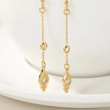 18K Gold Plated Drop Earrings with Cubic Zirconia featuring a rectangular and circular design, displayed on a wooden surface.
