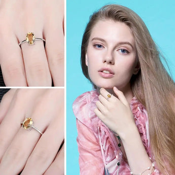 A hand wearing a 925 sterling silver oval citrine ring, highlighting the November birthstone jewelry piece.