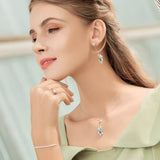 925 Sterling Silver Turtle Pendant with Blue Crystal Gem on a woman's neck