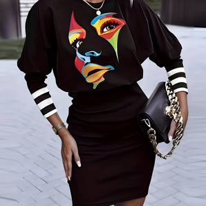 Colorful graphic blouse with an abstract face print, featuring short sleeves and a round neckline, displayed on a mannequin against a white background.