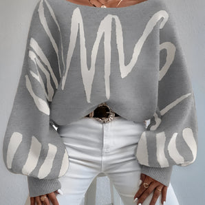 Abstract grey balloon sleeve sweater worn by a woman, showcasing trendy fall knitwear style with a focus on the distinctive oversized sleeves and comfortable fit.
