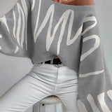 Abstract grey balloon sleeve sweater featuring trendy knitwear design, perfect for fall fashion, showcasing long sleeves and a comfortable fit on a woman's upper body.