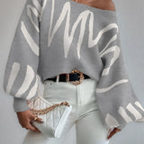 Abstract grey balloon sleeve sweater featuring a loose fit and trendy design, suitable for women's fall fashion. The sweater showcases a unique knit pattern with voluminous sleeves, styled for comfort and elegance.