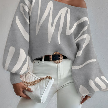 Abstract grey balloon sleeve sweater featuring a loose fit and trendy design, suitable for women's fall fashion. The sweater showcases a unique knit pattern with voluminous sleeves, styled for comfort and elegance.