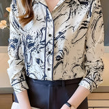Abstract print beige and navy women's blouse with a swirl pattern, featuring long sleeves and a classic collar, suitable for office wear.