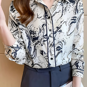 Abstract print beige and navy women's blouse with a swirl pattern, featuring a stylish office shirt design with long sleeves and a rounded neckline.