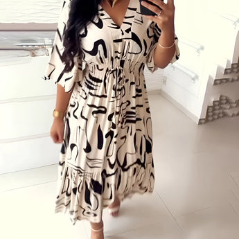 Abstract print v-neck summer dress with ruffle hem, designed for plus size, featuring short sleeves, a fitted waist, and a knee-length flowing skirt.