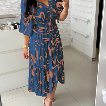 Abstract print V-neck summer dress featuring a ruffle hem, designed for plus size, in blue, with short sleeves and a flattering waistline.