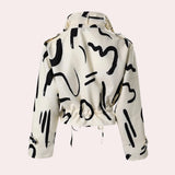 Black and white abstract print women's cropped jacket with drawstring waist, featuring long sleeves and a unique pattern design.