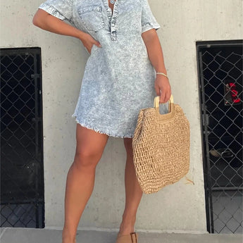Alt text: A trendy acid wash denim mini dress in gray, featuring a collared neckline and short sleeves. The dress is styled to fit a 3XL size.