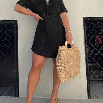 Acid wash denim mini dress featuring a collared neckline and short sleeves, styled in a trendy fashion. Model is wearing the dress in Nero color, size 3XL.