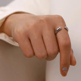 Adjustable minimalist two-tone silver gold ring worn on a hand, showcasing sleek modern jewelry design.