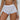 Adjustable side-tie beige bikini bottoms with luxury ruched design worn by a model shown from the waist down, showcasing the fit and style against a white background.