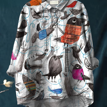 Animal print shirt featuring colorful bird illustrations and quirky patterns, displayed on a clothes hanger, with a white base, button-down collar, and long sleeves, in size 5XL.