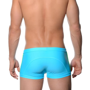 A man wearing aqua blue low-rise seamless performance briefs with moisture-wicking properties.