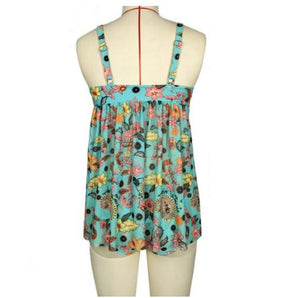 Woman wearing Aqua Floral Print Tankini, a lightweight sleeveless summer top with a round neck and fitted waist, in electric blue color with floral patterns.