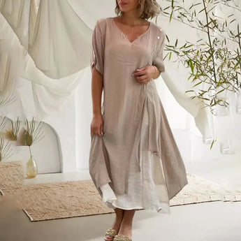 Asymmetrical blue V-neck maxi dress featuring side buttons, displayed on a mannequin showing the shoulder, sleeve, and waist details. The dress is styled for summer fashion and is available in size 4XL in a beige variant.