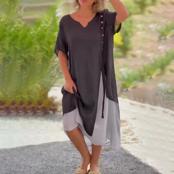 Asymmetrical blue V-neck maxi dress featuring side buttons, showcasing elegant summer fashion with a focus on the shoulder and waist areas.