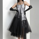 Avant-garde black plaid tulle midi dress featuring an edgy fashion design, showcasing a model wearing the dress with emphasis on the shoulder, sleeve, waist, and thigh areas. The dress is a one-piece garment, styled as a day dress, with a knee-length hem.