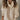 
A woman wearing a khaki 3XL baby blue balloon sleeve turtleneck sweater, showcasing the chic knit design.