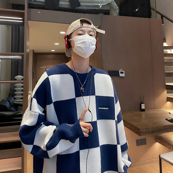 Balenciaga Men's Luxury Striped Wool Crewneck Sweater in blue, displayed on a mannequin, showcasing its elegant design with long sleeves and a classic crewneck style.