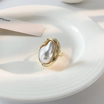 A luxurious gold cocktail ring for women featuring a stunning baroque pearl centerpiece.
