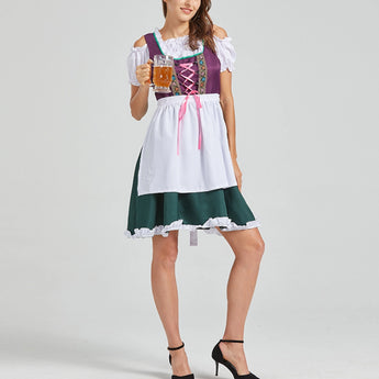 Bavarian Oktoberfest women's green and purple dirndl dress with short sleeves, featuring a fitted bodice and flared skirt. The model is wearing the dress in a vibrant purple color, size XL, accessorized with traditional footwear.