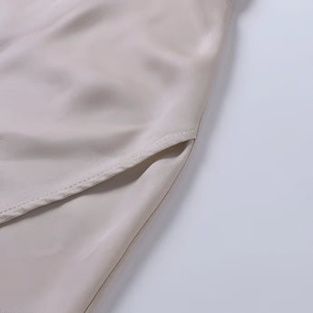 Beige adjustable strap cami featuring a versatile summer design with a zipper front.