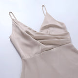 Beige adjustable strap cami top featuring a zipper design, suitable for versatile summer wear. The top has a sleeveless style, crafted from natural materials, with a focus on fashion design.