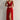 A woman wearing a red sheath dress with adjustable straps and a zipper, styled with a sleeveless design, suitable for both casual and formal summer occasions.